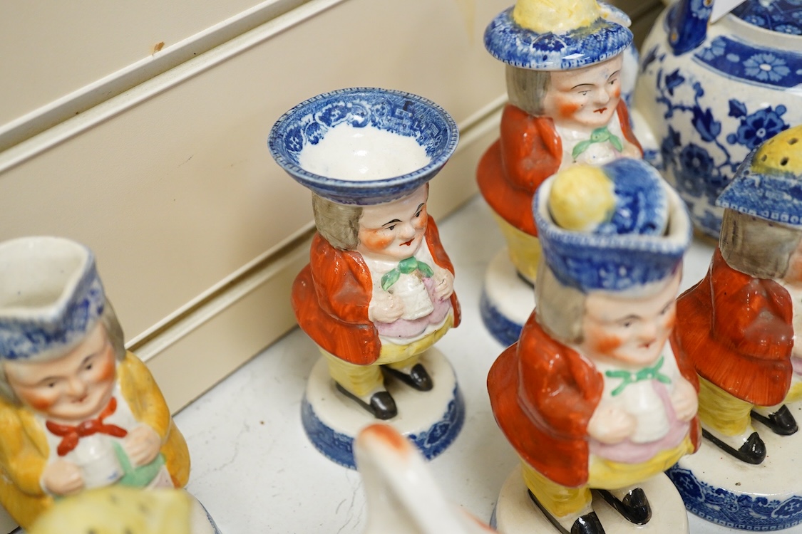 A large collection of English pottery cow creamers, Staffordshire figures and cruets a blue and white teapot and sponge ware dish-34cm diameter, (26)